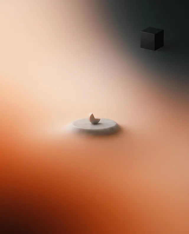 A smooth, minimalist composition featuring a simple, rounded stone resting on a circular surface, with a dark cube in the background. The image employs a soft focus and a warm color palette, creating a serene and contemplative mood.