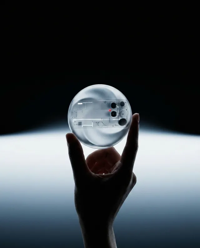 A hand holds a transparent orb containing a complex inner mechanism, captured in a sleek, minimalist style that emphasizes sophistication and intrigue. The image features a dark background with subtle gradients, invoking a sense of mystery through its monochromatic palette.