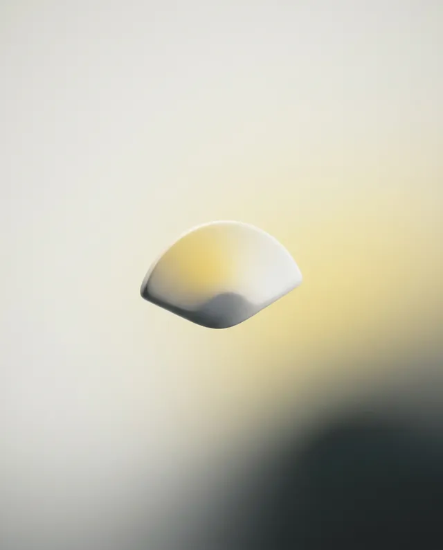 A minimalist digital illustration features a softly curved, semi-opaque shape floating against a gradient background of muted yellows and soft greys, evoking a tranquil and ethereal mood. The smooth lines and subtle colors enhance the sense of simplicity and calm.