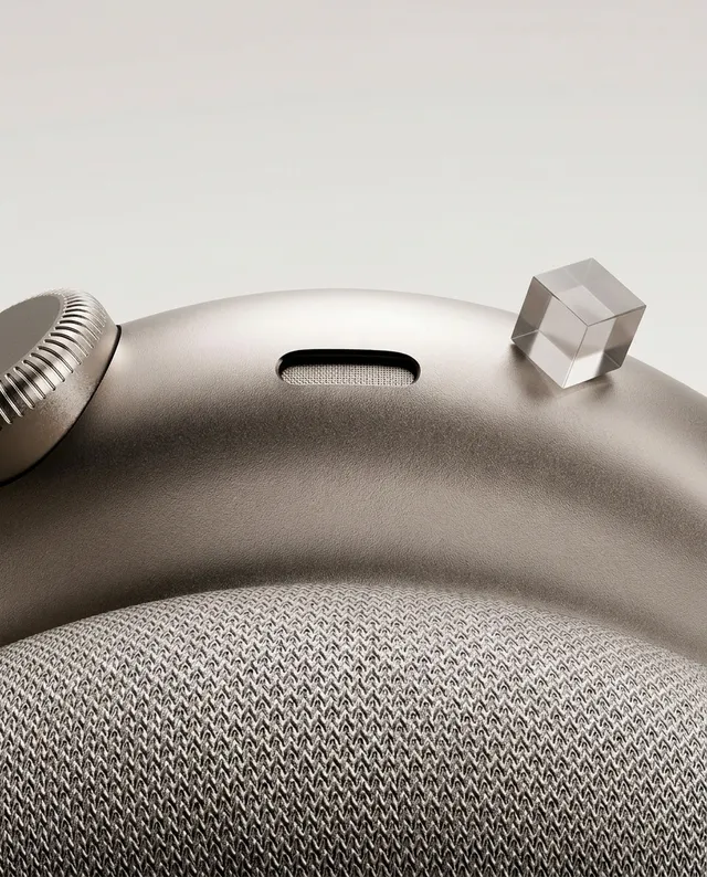 A close-up shot of a modern smartwatch featuring a sleek metallic finish and a textured fabric band, exuding a sophisticated and minimalist aesthetic. The image has a neutral color palette with soft gray tones, evoking a sense of elegance and contemporary design.