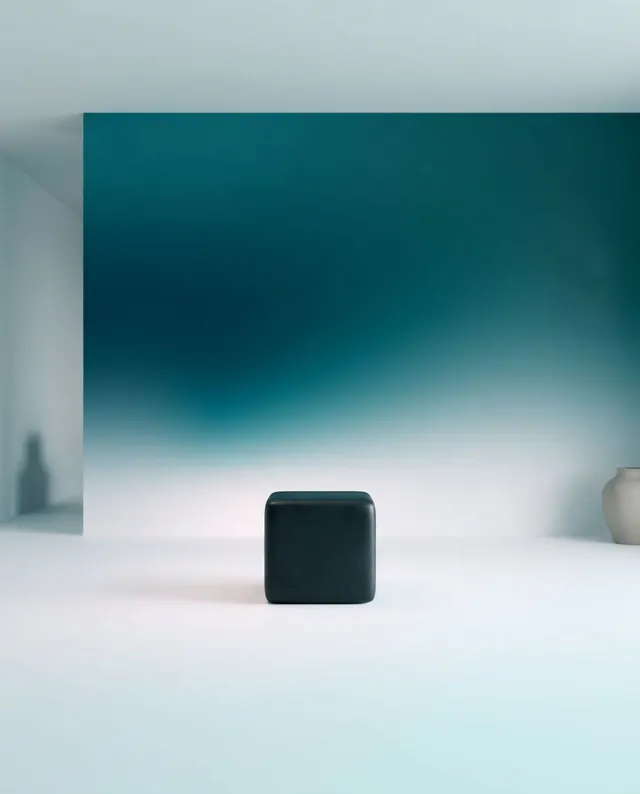 A minimalist scene featuring a sleek black cube at the center, set against a gradient backdrop that transitions from deep teal to soft white. The mood is serene and modern, highlighting simplicity with a clean, contemporary aesthetic.