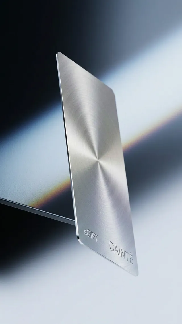 A sleek, metallic gift card is prominently displayed against a gradient background, emphasizing a modern and minimalist aesthetic. The cool tones of silver and subtle reflections create a sophisticated and polished mood.