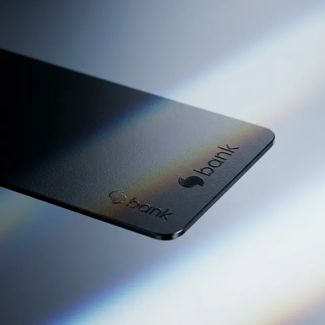 A sleek black bank card is prominently displayed against a blurred gradient background, showcasing a subtle play of light with iridescent hues. The minimalistic design evokes a sense of modern sophistication and security.