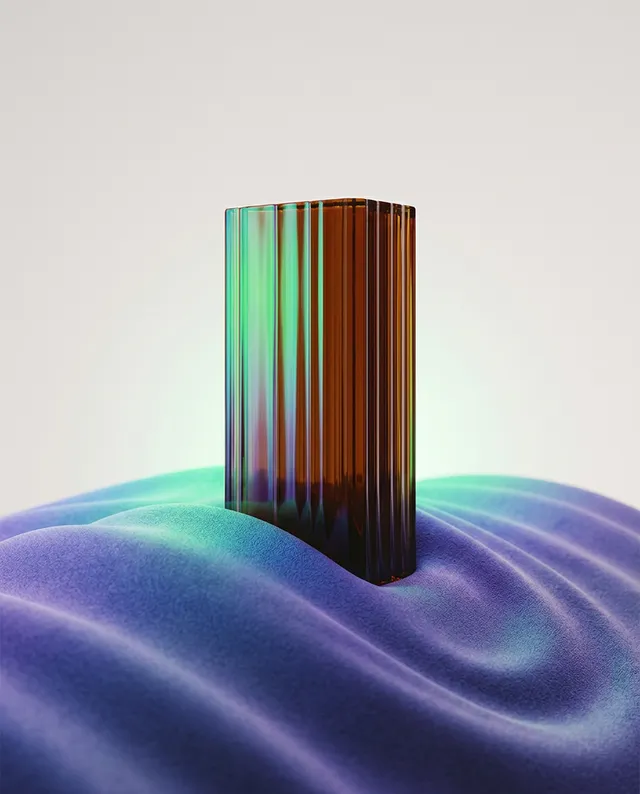 This editorial photography image features a textured, amber glass object with vertical lines placed atop a soft, purple fabric that creates a smooth, dreamy mood. The dominant colors are rich amber and vibrant purple, with subtle green reflections enhancing the ethereal atmosphere.